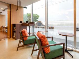 a lobby with two chairs and a table at Comfort Hotel Akita in Akita