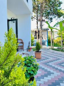 a patio with a bench and some plants at Hotel Tramonto in Chakvi
