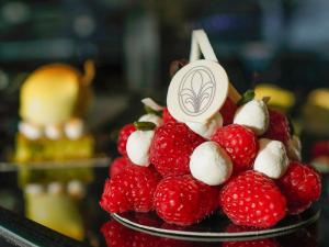 a pile of strawberries and marshmallows on a plate at Fairmont Hotel Vier Jahreszeiten in Hamburg