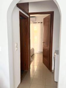 an open door to a hallway with a bathroom at AQUALIA Apartment 2 in Karpathos Town