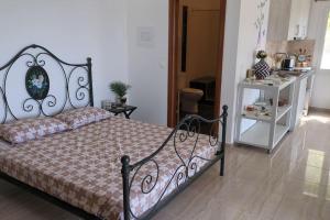 a bedroom with a bed and a white cabinet at Villa Luna Apartment in Vourliótai