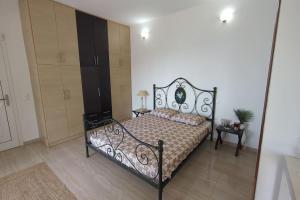 a bedroom with a bed and a dresser in it at Villa Luna Apartment in Vourliótai