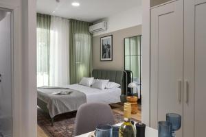 a bedroom with a bed and a table with a chair at Agostini Residence - SELF CHECK-IN ONLY in Rijeka