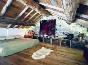 a bedroom with a bed and a stone wall at Mas Montet Chez Raphael in La Valette