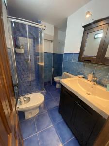 a bathroom with a sink and a shower and a toilet at Casa Rural El Molino in Macastre