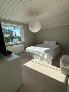 a bedroom with a bed and a large window at House by the ocean in Mariehamn in Mariehamn