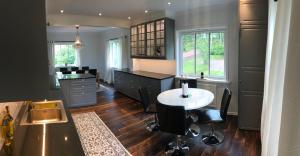 a kitchen with a desk and a table and chairs at House by the ocean in Mariehamn in Mariehamn