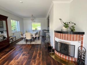 a living room with a fireplace and a dining room at House by the ocean in Mariehamn in Mariehamn