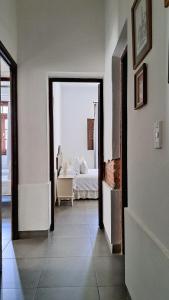 a room with a bedroom with a bed and a doorway at Casa Kolla - 2 bedrooms with private garage in downtown Salta in Salta +5 photos