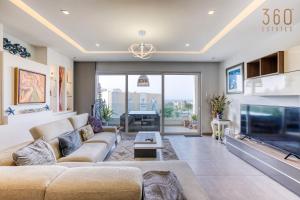 a living room with a couch and a tv at A Stunning 3BR Home with private terrace in Swieqi by 360 Estates in Is-Swieqi