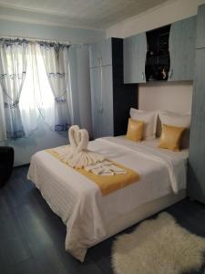 a bedroom with two beds with towels on the bed at Casa Elisei in Asău