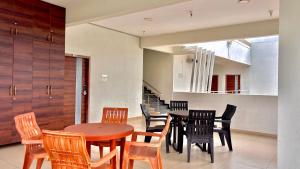 a dining room with a wooden table and chairs at Chandana green view resort Hampi in Gangāwati +40 photos