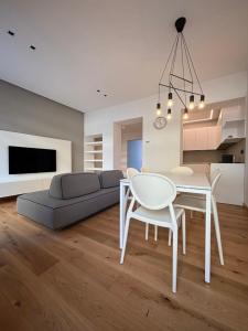 a living room with a couch and a table and chairs at Residenza la Torretta in Domodossola