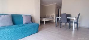 a living room with a couch and a table with chairs at Apartamentos Green Park Tenerife in San Miguel de Abona +10 photos