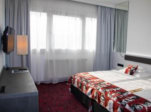 En eller flere senger på et rom på ARCOTEL Nike Linz