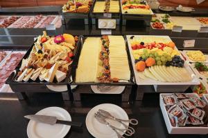 a buffet with many different types of food on a table at ARCOTEL Castellani Salzburg in Salzburg