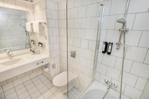 łazienka z toaletą, umywalką i prysznicem w obiekcie ARCOTEL Kaiserwasser Wien w Wiedniu