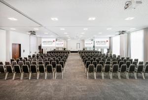 an empty room with chairs and podiums in it at ARCOTEL Kaiserwasser Wien in Vienna