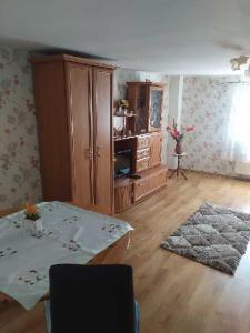 a living room with a table and a cabinet at Jagiellonka in Inowrocław
