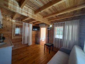 a living room with a couch and a wooden ceiling at Adrasan Eren Apart evleri in Adrasan