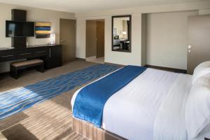 a hotel room with a large bed and a desk at Holiday Inn St Louis Downtown/Convention Center, an IHG Hotel in Saint Louis