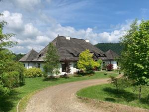 a house with a gravel road in front of it at Dwór na Wrzosowisku in Cisna