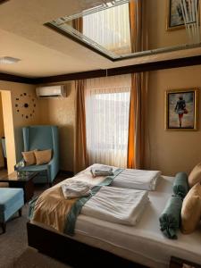 a bedroom with a large bed and a window at Villa Aroma 2 in Orašje