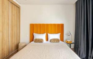 a bedroom with a large bed with an orange headboard at Atlantic Suite View 1 in Casablanca