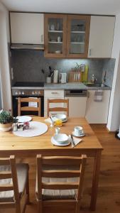 a kitchen with a wooden table with chairs and a tableablish at Apartment Katharina in Spital am Pyhrn +23 photos