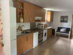 a kitchen with a sink and a stove top oven at Casa Romeo in Brion