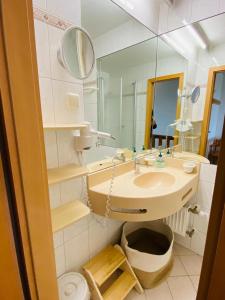 a bathroom with a sink and a mirror at Ferienwohnung Schönblick in Sankt Englmar