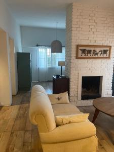 a living room with a couch and a fireplace at Casa Drummond in Ciudad Lujan de Cuyo