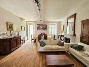 a living room with a couch and a table at Maison d Americain a Figarella au Cap Corse in Santa-Maria-di-Lota