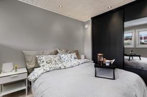a bedroom with a large bed with a black accent wall at Rekkehus sentralt i Stavanger - nære ONS messen in Stavanger