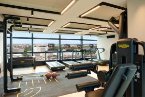 a gym with cardio equipment in a building at Hilton Rome Eur La Lama in Rome