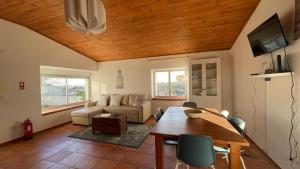a living room with a table and a couch at The Sunset Spot in São Bartolomeu