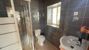 a bathroom with a toilet and a sink at The Sunset Spot in São Bartolomeu +50 photos