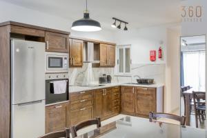A kitchen or kitchenette at Charming & Central 3BR Apt with Private Terrace by 360 Estates