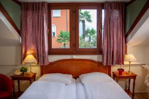 Postel nebo postele na pokoji v ubytování Easy Stay by Hotel La Perla
