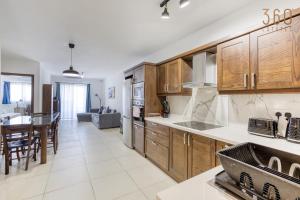 A kitchen or kitchenette at Charming & Central 3BR Apt with Private Terrace by 360 Estates