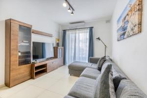 A television and/or entertainment centre at Charming & Central 3BR Apt with Private Terrace by 360 Estates