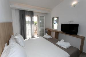 Postel nebo postele na pokoji v ubytování Hotel Philoxenia