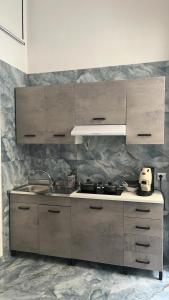 a kitchen with a sink and a stove top oven at Aurora House 2 in Naples