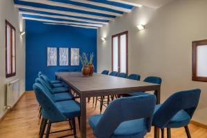 a dining room with a table and blue chairs at Hotel-Boutique by Gonzalo Sesma in Cervera del Río Alhama