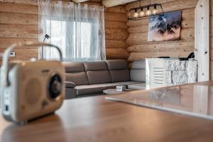 a living room with a couch and a table at Zrub Šumiac in Šumiac +48 photos