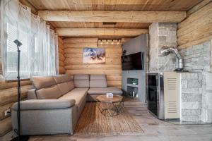 a living room with a couch and a stone wall at Zrub Šumiac in Šumiac
