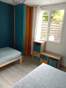a bedroom with a bed and a window and a bedskirts at Le mas des Landes in Vielle-Saint-Girons