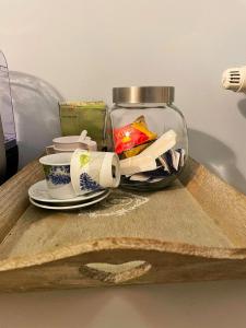 a tray with a plate and a cup and a glass jar at Alla Scaletta - Stanze con Bagno Privato e WiFi a Pochi Passi dal Duomo in Mirandola +41 photos