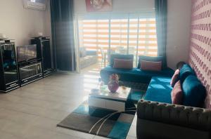 a person laying on a couch in a living room at Appart Cosy Résidence Perla in Saïdia