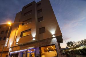 a tall building with a light on top of it at Piccolo Hotel Allamano in Grugliasco